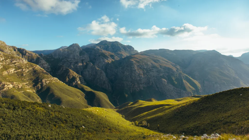 Nature inspired Scenic view of majestic mountains under a clear blue sky, showcasing their rugged peaks and natural beauty.