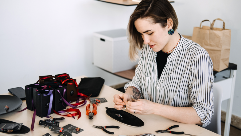 A woman is making crafts for her Etsy shop.