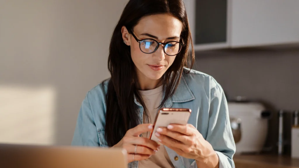 A woman is scrolling on her phone.