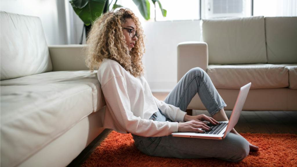 A woman is working on a laptop.