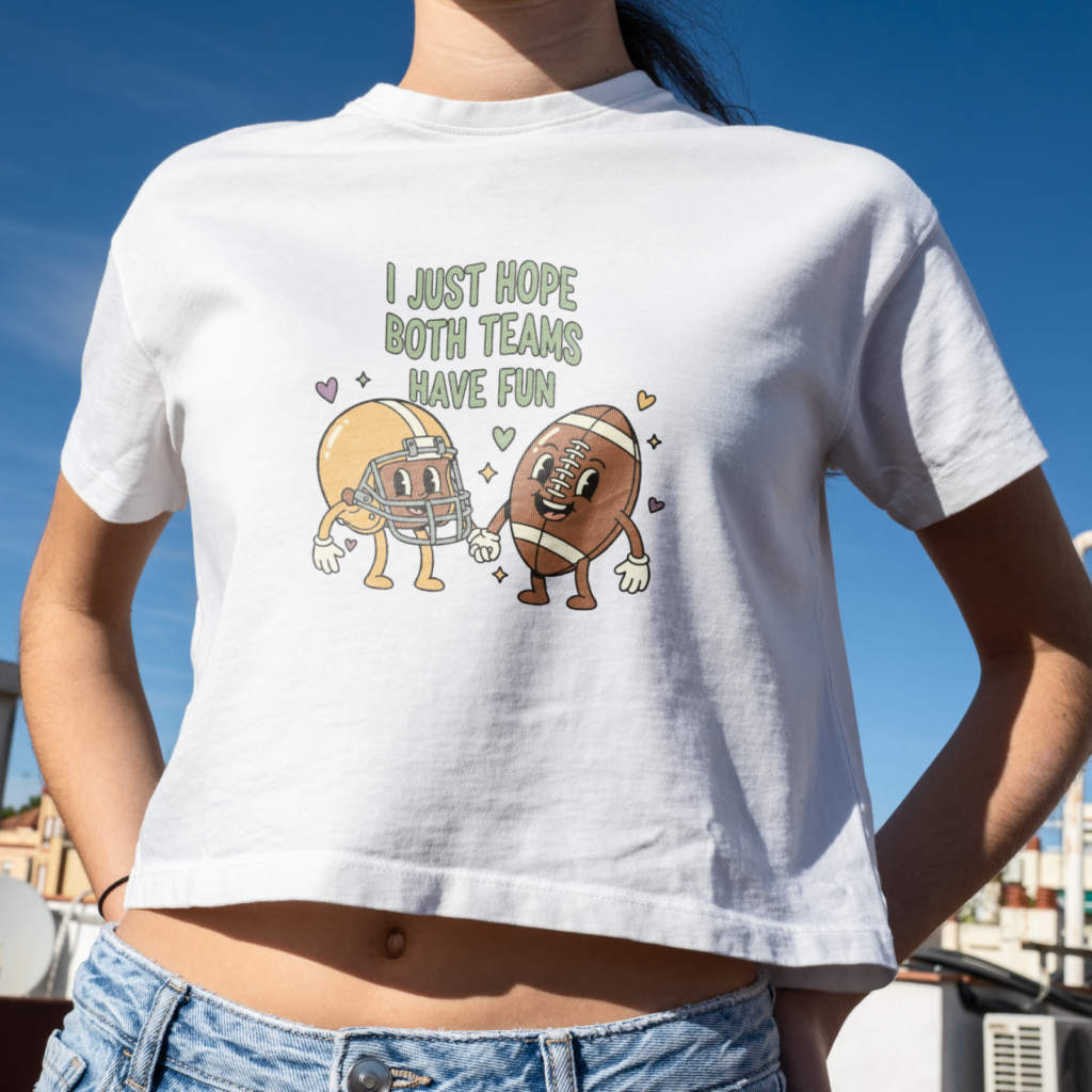 09 I just hope both teams have fun A woman wearing a white crop top with cartoon football and helmet characters holding hands, reads "I just hope both teams have fun".