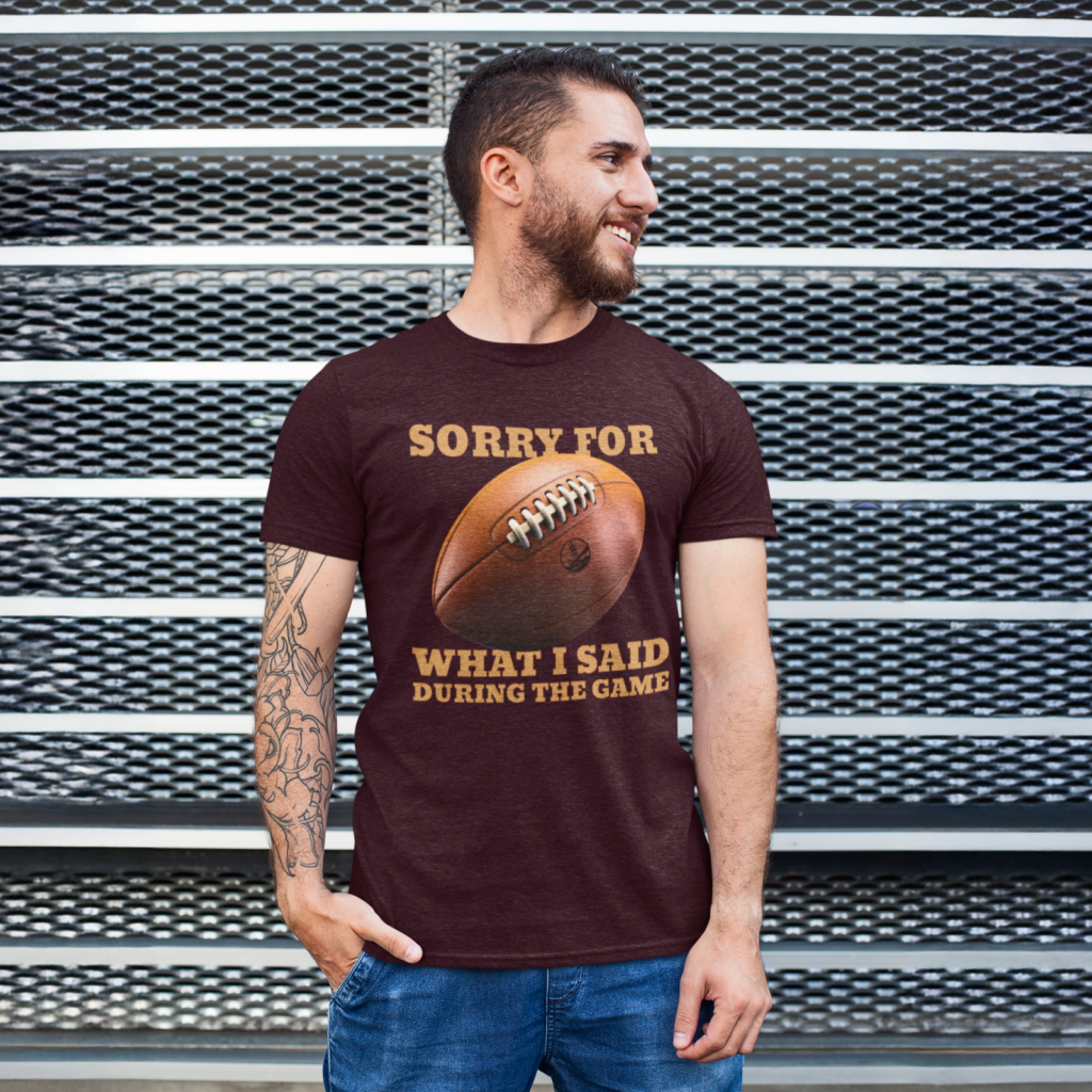15 Sorry for what I said during the game t shirt A man with a beard, smiling, wearing a maroon t-shirt with a football graphic and text, "Sorry for what I said during the game".