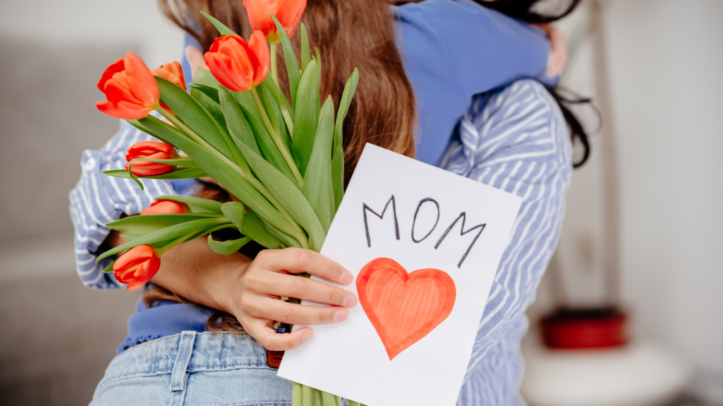 Mother's Day card featuring tulips, with a mother joyfully holding a card adorned with a heart.
