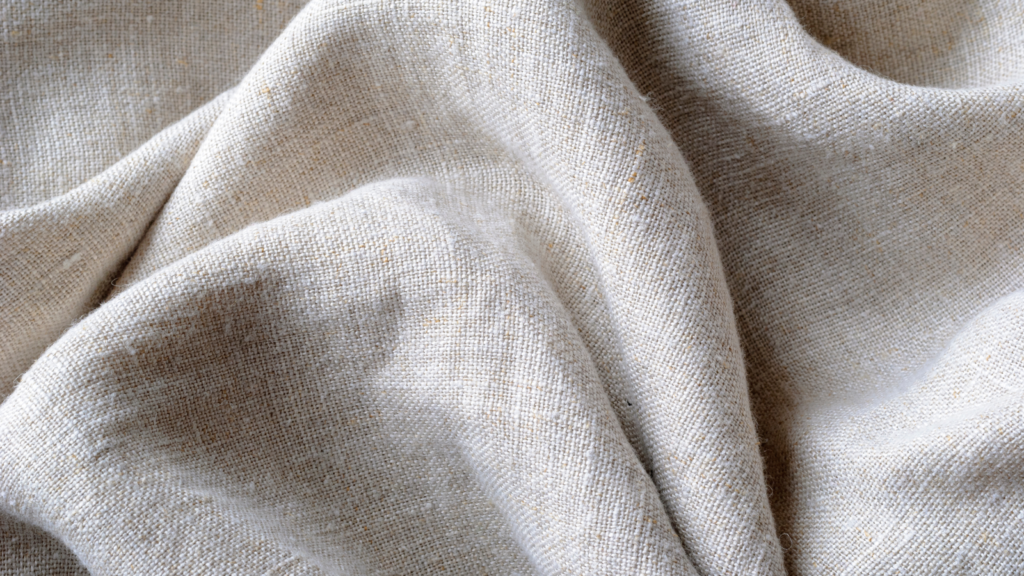 Close-up of a white linen fabric, showcasing its texture and natural fibers.
