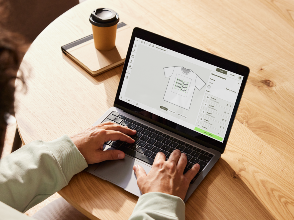 A person is using a laptop to create a custom product using Printify’s Product Creator.