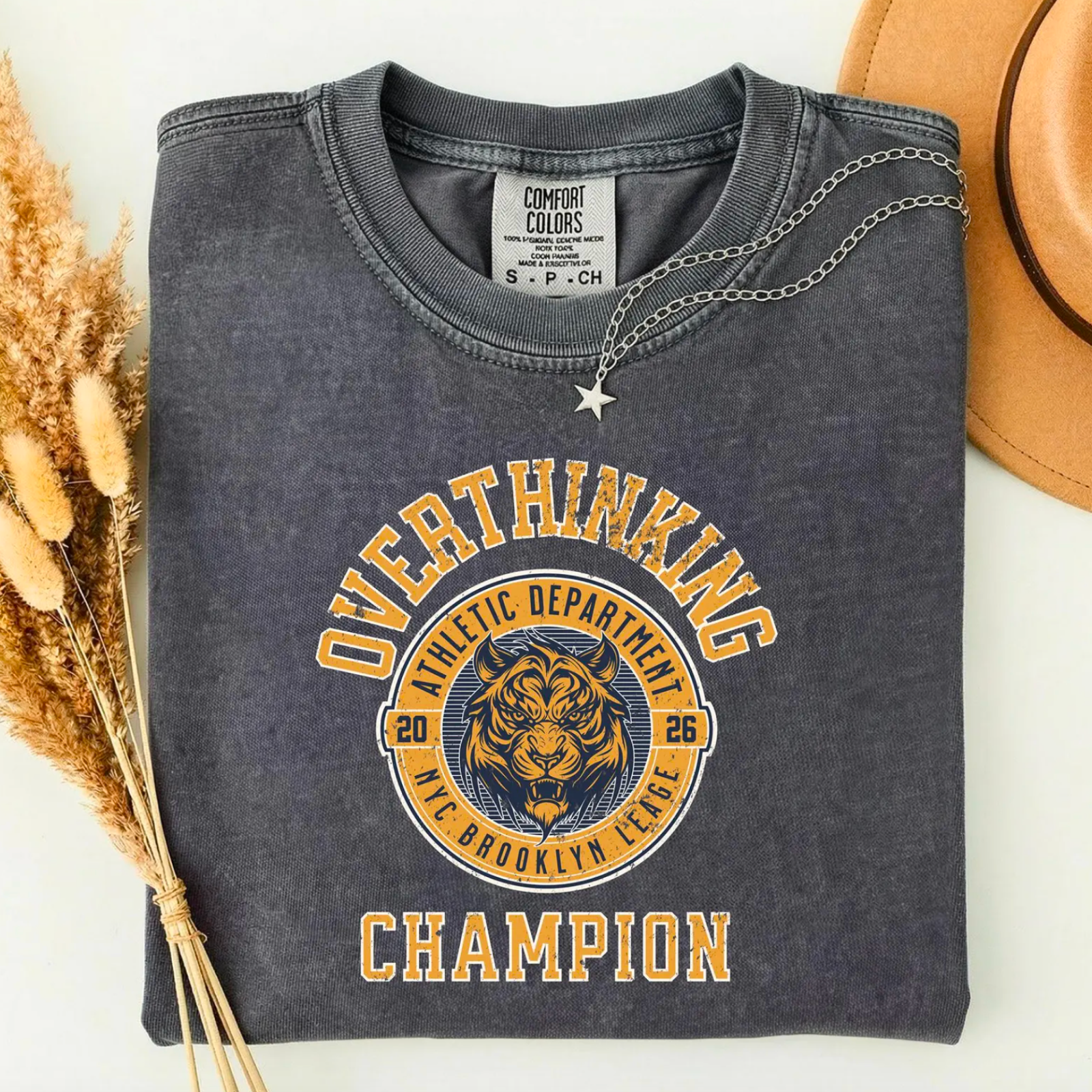 Gray sweatshirt with "Overthinking Champion" text and tiger graphic.