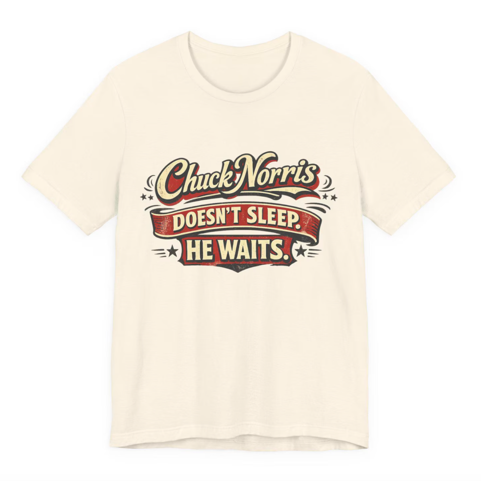 Beige T-shirt with stylized red and black text reading "Chuck Norris doesn't sleep. He waits."