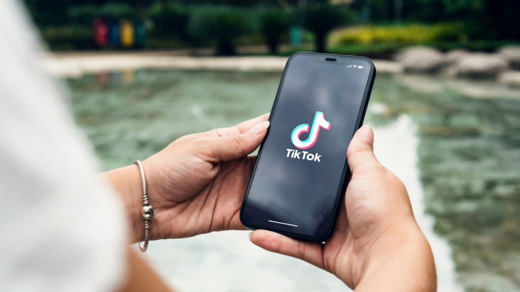 2 TikTok Shop platform fees in 2026 Person opening the TikTok app