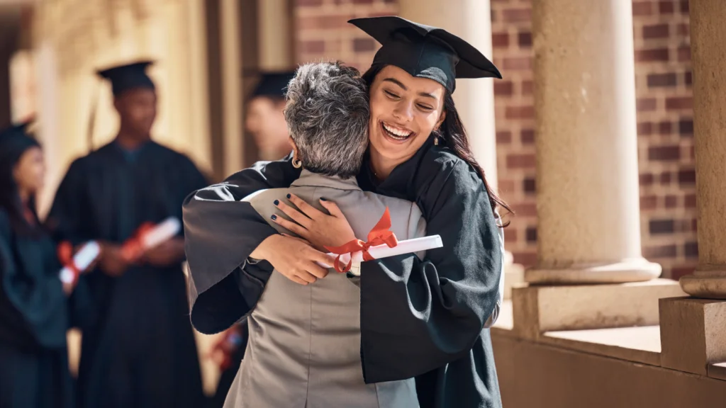 Q2 Gifting season and graduation A joyful graduate in cap and gown hugs an older person, holding a diploma.