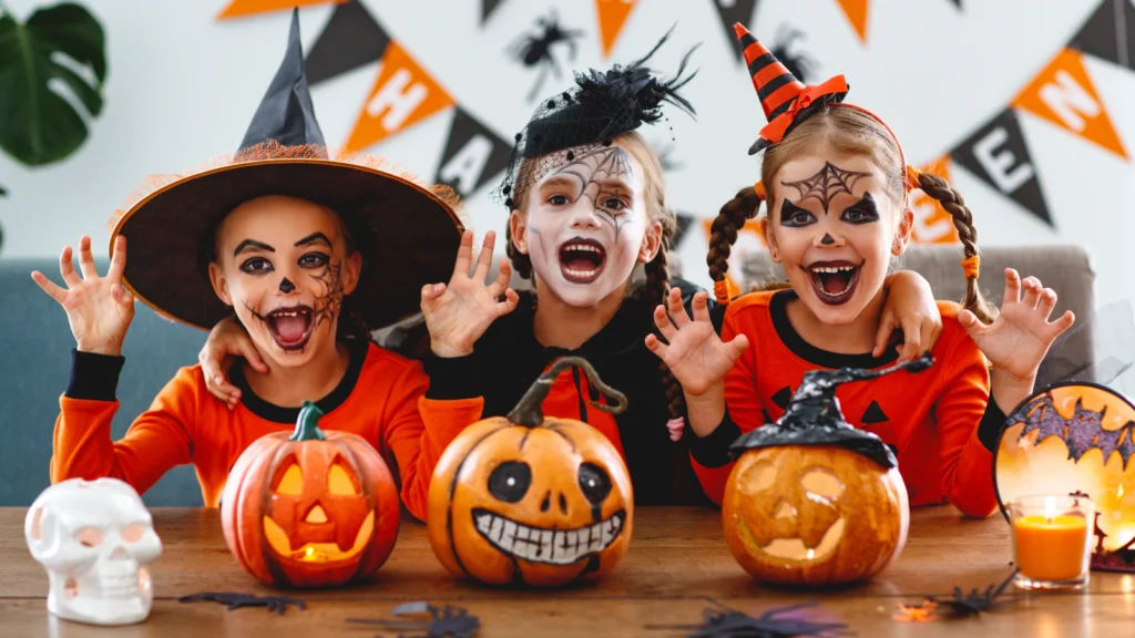 Q4 The big league of TikTok commerce Three children in Halloween costumes sit at a table with carved pumpkins.