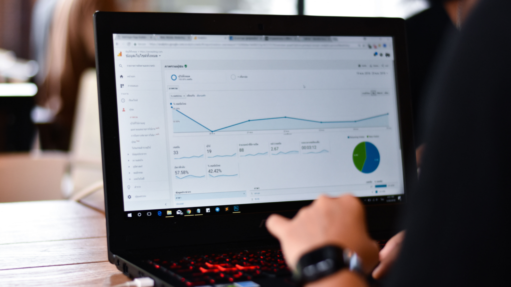 3 Traffic sources show where your shoppers actually come from A person focused on a laptop displaying a graph, analyzing data for a project or presentation.
