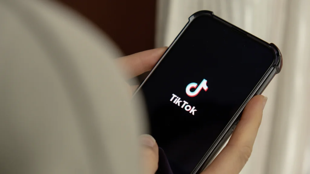 Content ideas for your Printify samples A person holds a smartphone displaying the TikTok logo on a black screen.