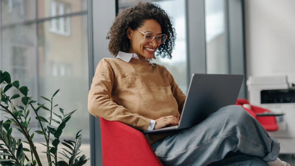 A woman is working on her laptop