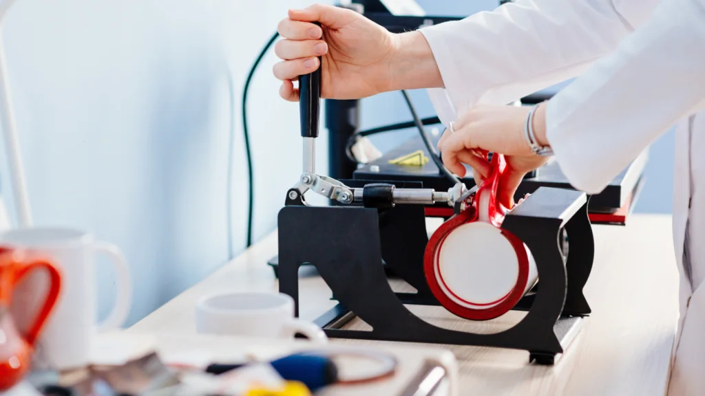 Transfer printing A person in a lab coat using a heat press machine to apply a design onto a mug.